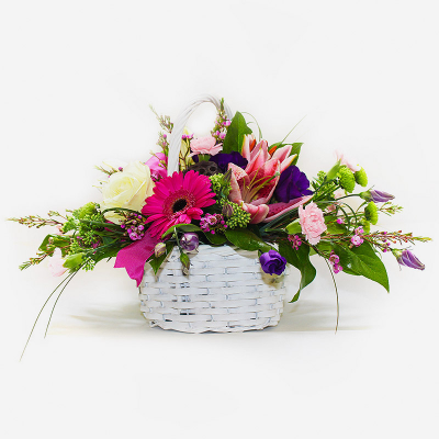 A Basket that Delights - A delightful basket arrangement of pinks, creams and purple mixed with complementary foliage.